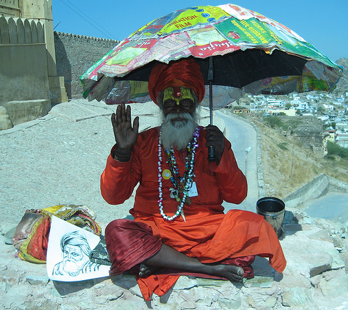 Indian guru with umbrella.