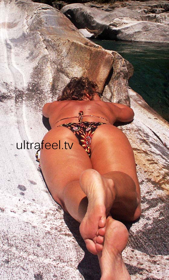 Woman in bikini on Verzasca rock river.