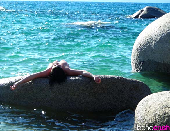 Naked woman on a stone at Lake Tahoe, USA. 