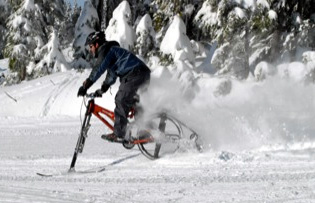 Ktrak ski bike. Man riding the ktrakcycle.