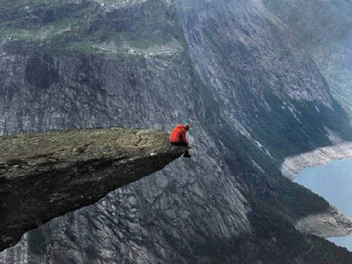 Man sitting on a cliff.